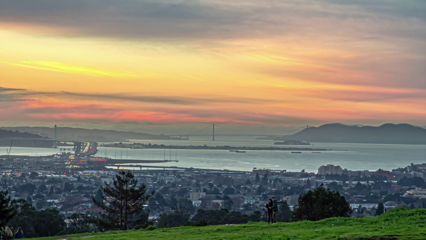 Static shot over San Francisco downtown city and bay area with heavy traffic movement in timelapse at dusk.