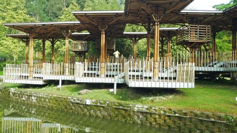 Kuala Lumpur, Malaysia - June 1,2022 : Landscape morning view of the Bamboo Playhouse in Kuala Lumpur Perdana Botanical Gardens, people can seen exploring around it.