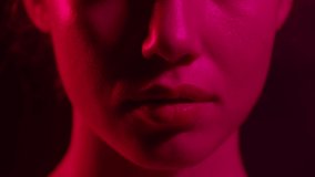 A close-up of the girl's face in the neon multi-colored light of the nightclub slowly rises.  - Powered by Shutterstock - Get 15% off with code: PIKWIZARD15