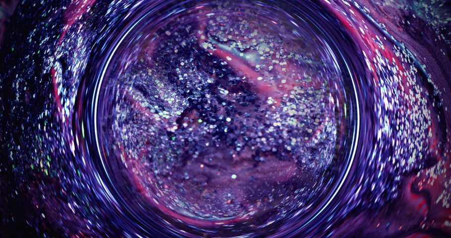 Glitter ink background. Paint mix. Shimmering liquid leak round circle. Blur blue purple pink shiny wet fluid flow motion. Abstract texture shot on RED Cinema camera.