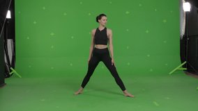 GREEN SCREEN CHROMA KEY Young sporty female yoga or pilates coach showing exercises. Online remote workout training, VR or mobile fitness application 