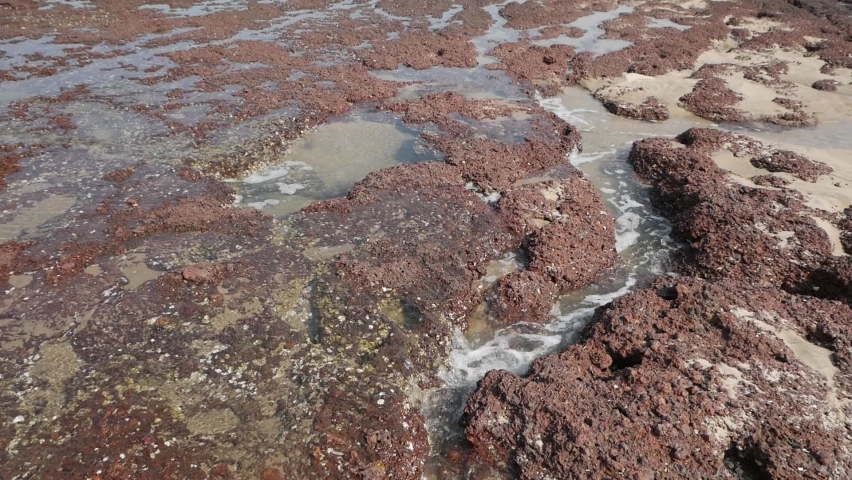 Sea water flowing through rocks on a coastline at Bhogwe state Maharashtra India  02 20 2022