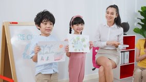 Caucasian beautiful woman teacher teaching a lesson to kid at school. Attractive female instructor master explain and educate children student with fun activity in classroom at preschool kindergarten. - Powered by Shutterstock - Get 15% off with code: PIKWIZARD15