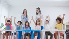 Caucasian beautiful woman teacher teaching a lesson to kid at school. Attractive two female instructor explaining and educate children student with fun activity in classroom at preschool kindergarten. - Powered by Shutterstock - Get 15% off with code: PIKWIZARD15