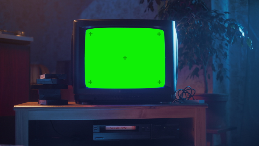 Close Up Footage of a Dated TV Set with Green Screen Mock Up Chroma Key Template Display. Nostalgic Retro Nineties Technology Concept. Royalty-Free Stock Footage #1091015789