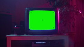 Close Up Footage of a Dated TV Set with Green Screen Mock Up Chroma Key Template Display. Nostalgic Retro Nineties Technology Concept.