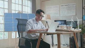 Side View Of Unsatisfied Asian Man Working With Laptop Computer With Model Of A Small House With Solar Panel
 - Powered by Shutterstock - Get 15% off with code: PIKWIZARD15