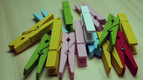Rotating  colorful wooden clothespins. Top view