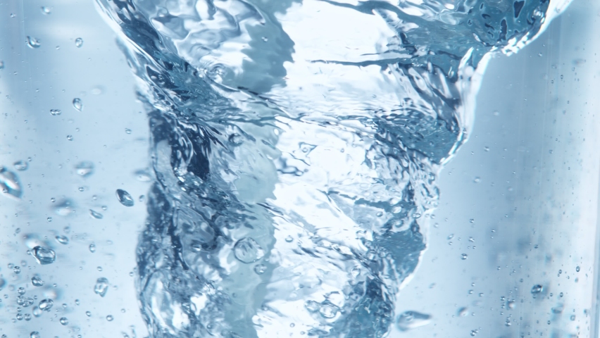Super Slow Motion Shot of Water Whirl on Light Blue Background at 1000fps. Royalty-Free Stock Footage #1091020933