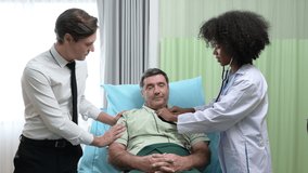 A young female doctor who specializes in heart disease. Advise patients with heart disease symptoms and the patient's son. that the results of the treatment improved until they were able to go home - Powered by Shutterstock - Get 15% off with code: PIKWIZARD15