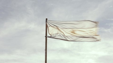 Argentina Flag Against Blue Cloudy Sky. Close Up.