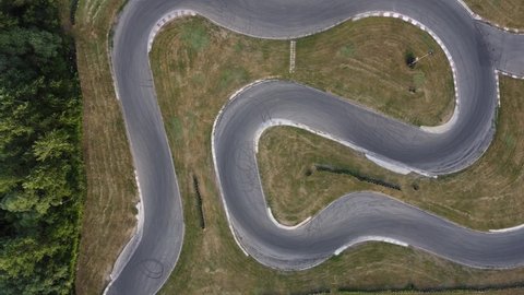A stunning aerial view of a go kart track while a driver races.