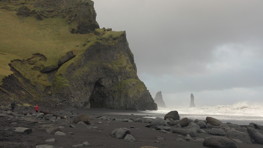 Iceland. Ocean waves hitting against the rocks on a stormy day. Huge waves crash against the rocks.