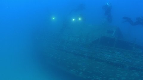 Underwater scene - Scuba divers in a shipwreck in cloudy water