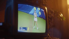 Close Up Footage of a Dated TV Set Screen with Live Sports Tennis Match Broadcast. Athletic Female Player in White Loses a Point. Nostalgic Retro Nineties Technology Concept.