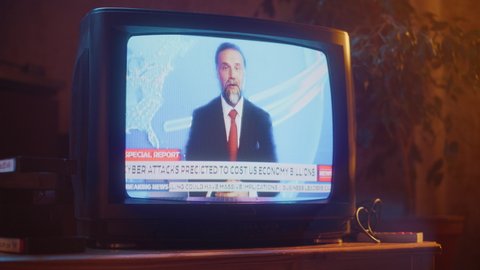 Close Up Footage of a Dated TV Set Screen with Breaking News Report. Handsome Middle Aged Anchorman Reads Important News on Live Television Broadcast. Nostalgic Retro Nineties Technology Concept.