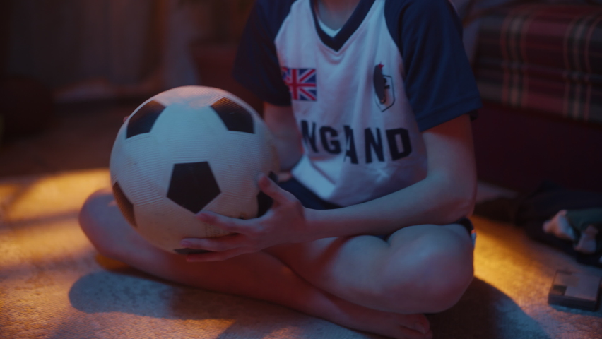 Close Up Portrait of a Young Soccer Fan Watching a Cup Match on TV set at Home. Handsome Boy Supporting His Favorite Football Team, Feeling Proud When Players Score a Goal. Happy Childhood Concept. Royalty-Free Stock Footage #1091044595
