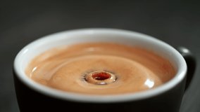 Coffee Droplet Falling and Making Splash in the Black Coffee Cup with Crema on Dark Background - Powered by Shutterstock - Get 15% off with code: PIKWIZARD15
