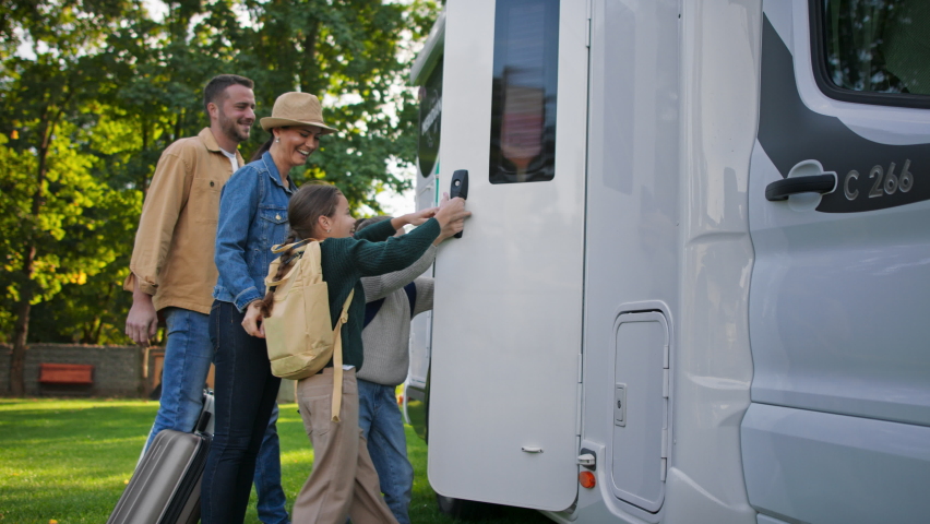 Side view of young family with suitcases going to caravan outdoors at park. | Shutterstock HD Video #1091058101
