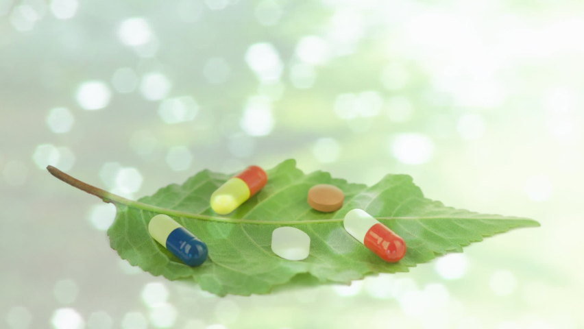 Animation of glowing water with pills and medication on leaf. Global science, medicine and healthcare services concept digitally generated video.