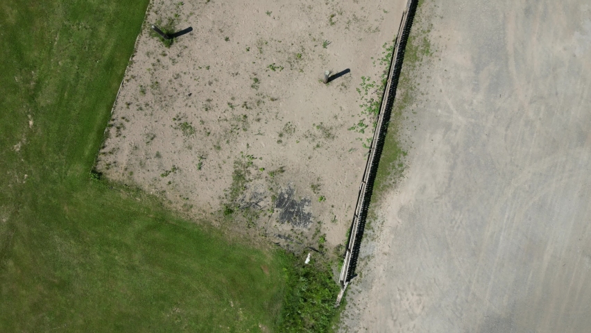Kids play basketball near playground and mini putt summer camp, overhead aerial
