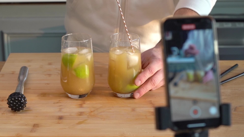 Shooting Video Of A Bartender Making Cocktail Drinks. Food Influencer Creating Vlog For Social Media Content - static Royalty-Free Stock Footage #1091063515