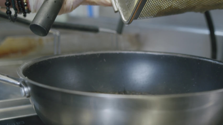 A professional chef in Italy is prepairing a plate of pasta and scampi in his kitchen - 04