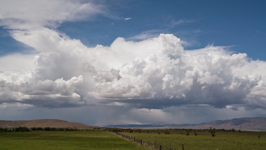 Thunderstorm building and moving over the landscape bringing wind and rain through Utah.