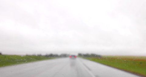 Windshield windscreen wipers working during a rainy road trip