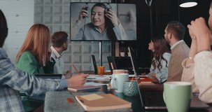 Business people talk to female boss via web conference, check video call connection at office table meeting slow motion.