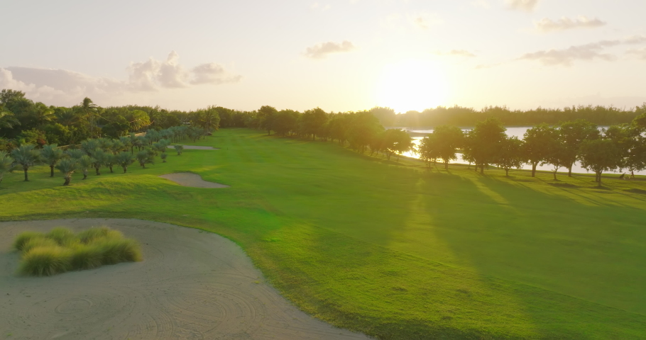 Golf hotel coast Indian ocean. Golf course and villas on the beach. Aerial view of Golf course. Establishing shot, drone flying over golf club. Summertime, sunset. The life of rich people. Mauritius | Shutterstock HD Video #1091079179