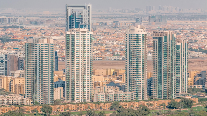Aerial view of greens district area timelapse from Dubai marina. Towers and skyscrapers with many villa houses on a background from above