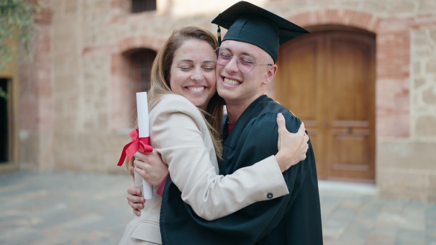Man and woman mother and son hugging each other celebrating graduation at university Royalty-Free Stock Footage #1091080837