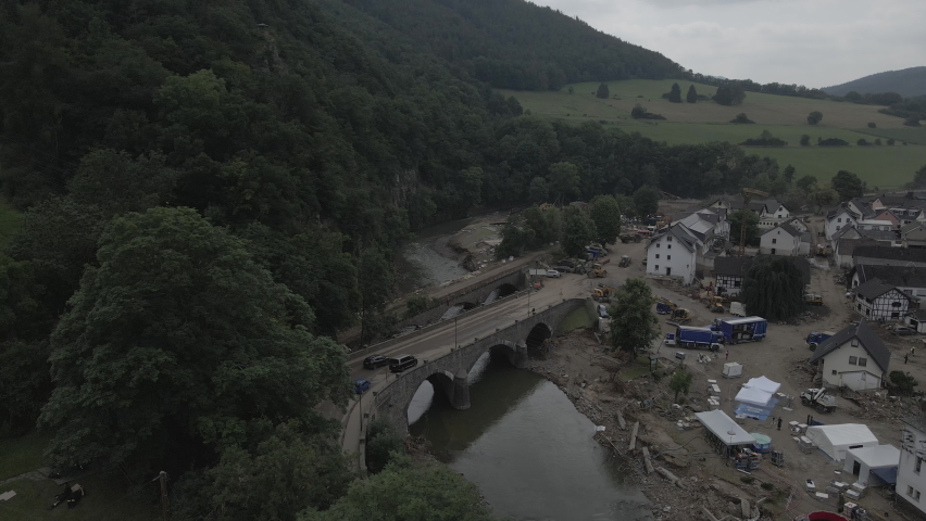 Strong flooding occurred in the Ahrweiler region in the summer of 2021, causing damage to many houses and bridges.  
The drone shows how the village "Schuld" in Rhineland-Palatinate has been affected  Royalty-Free Stock Footage #1091085559