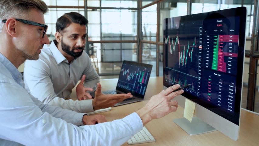 Two diverse crypto traders brokers stock exchange market investors discussing trading charts research reports growth using pc computer looking at screen analyzing invest strategy, financial profit. Royalty-Free Stock Footage #1091092359