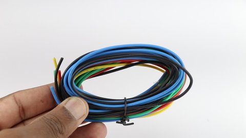 Reel of new multicolored wire used in connections of electronics held in the hand