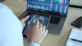 Crypto trader investor analyst broker using tablet analyzing digital cryptocurrency exchange stock market trading chart report thinking of investing funds risks doing global analysis. Closeup - Powered by Shutterstock - Get 15% off with code: PIKWIZARD15