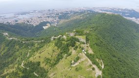 Inscription on video. Genoa, Italy. Forte Sperone is a key point of the 19th-century Genoese fortifications and is located on top of the Mura Nuove. View of Genoa. Heat burns text, Aerial View, Point