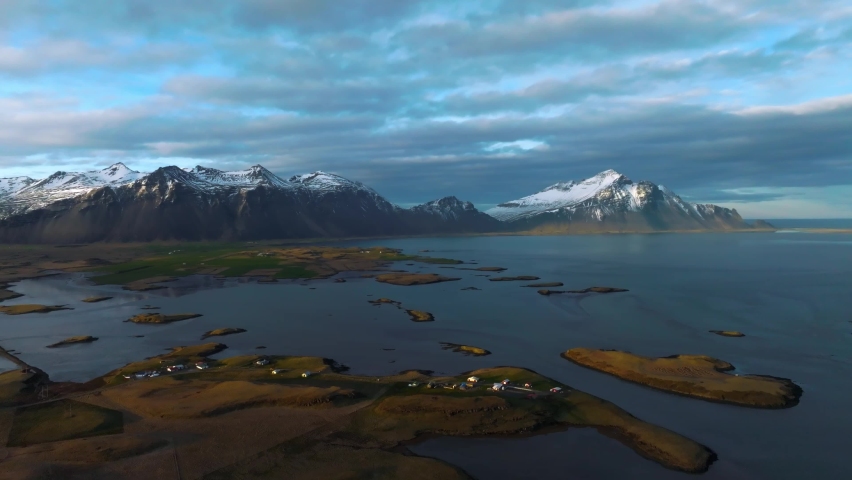 Colorful sunset over the mountains. Fantastic aerial views of the landscape in Iceland with Vestrahorn mountains on the horizon.