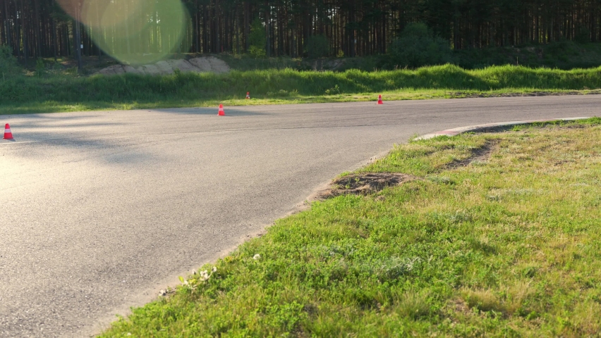 Riding Motorcycle In Sunset Sunshine With Sun Flare On Track.