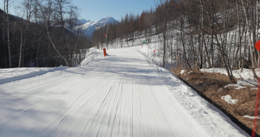 Skiing in the alps, slow, easy slope, realxing ride, forst person point of view, 4k 60p footage