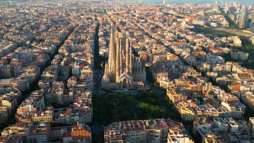 Aerial view of Barcelona City Skyline and Sagrada Familia Cathedral. Flying around the architectural masterpiece of Gaudi at sunset | Shutterstock HD Video #1091102813