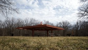 Time-lapse video of clouds passing over picnic shelter in public park