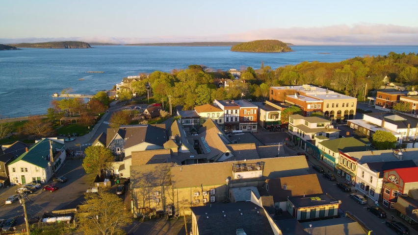 Bar Harbor historic town center aerial view at sunset, with Cadillac Mountain in Acadia National Park at the background, Bar Harbor, Maine ME, USA. 