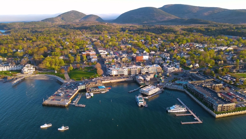 Bar Harbor historic town center aerial view at sunset, with Cadillac Mountain in Acadia National Park at the background, Bar Harbor, Maine ME, USA.  Royalty-Free Stock Footage #1091105835