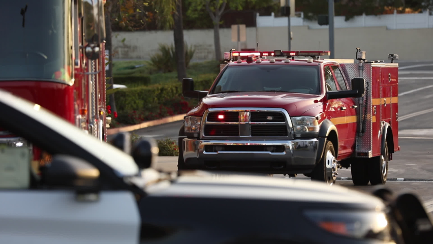 Police, fire, and paramedic units respond to the scene of an emergency. Royalty-Free Stock Footage #1091107113