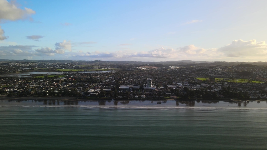 Flying sideways along the coast line of Orewa beach