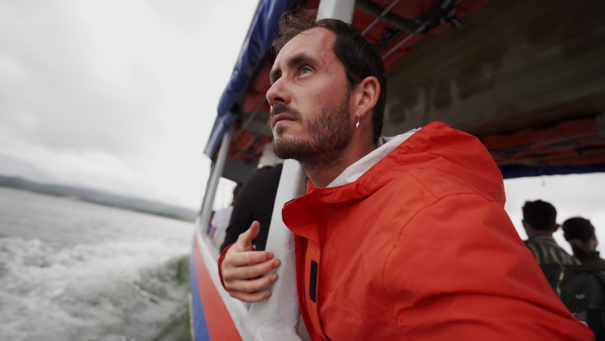 Caucasian young traveller standing in a touristic boat crossing natural lake in Costa Rica Central America wilderness nature