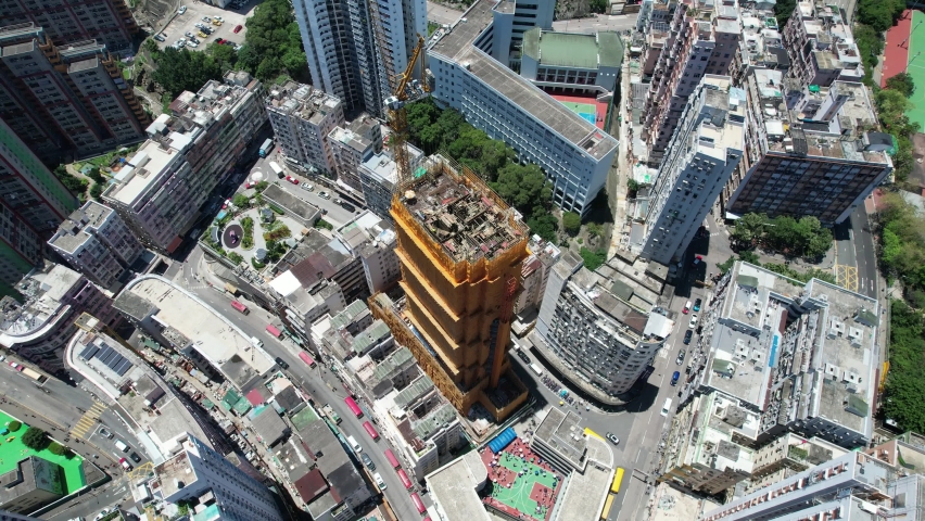 Commercial and residential construction development project in Kwun Tong of Hong Kong city, becoming the newest business district near Kowloon Bay and Victoria harbor, Aerial drone skyview | Shutterstock HD Video #1091108935