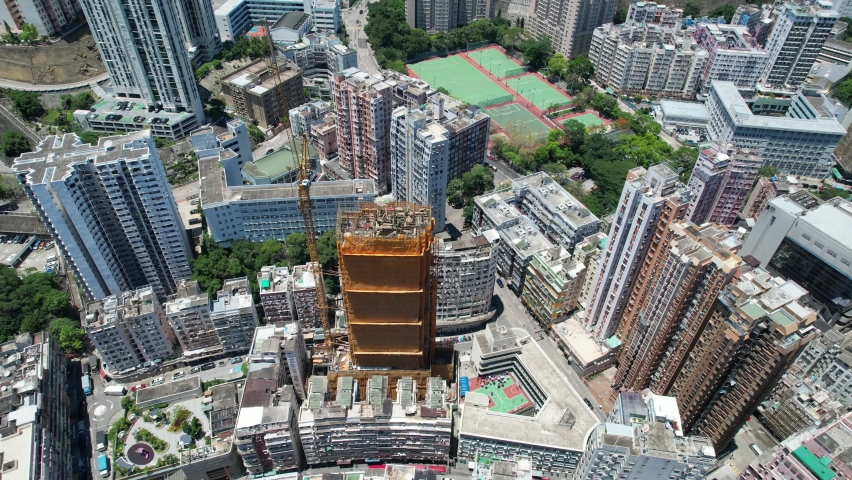 Commercial and residential construction development project in Kwun Tong of Hong Kong city, becoming the newest business district near Kowloon Bay and Victoria harbor, Aerial drone skyview | Shutterstock HD Video #1091108951